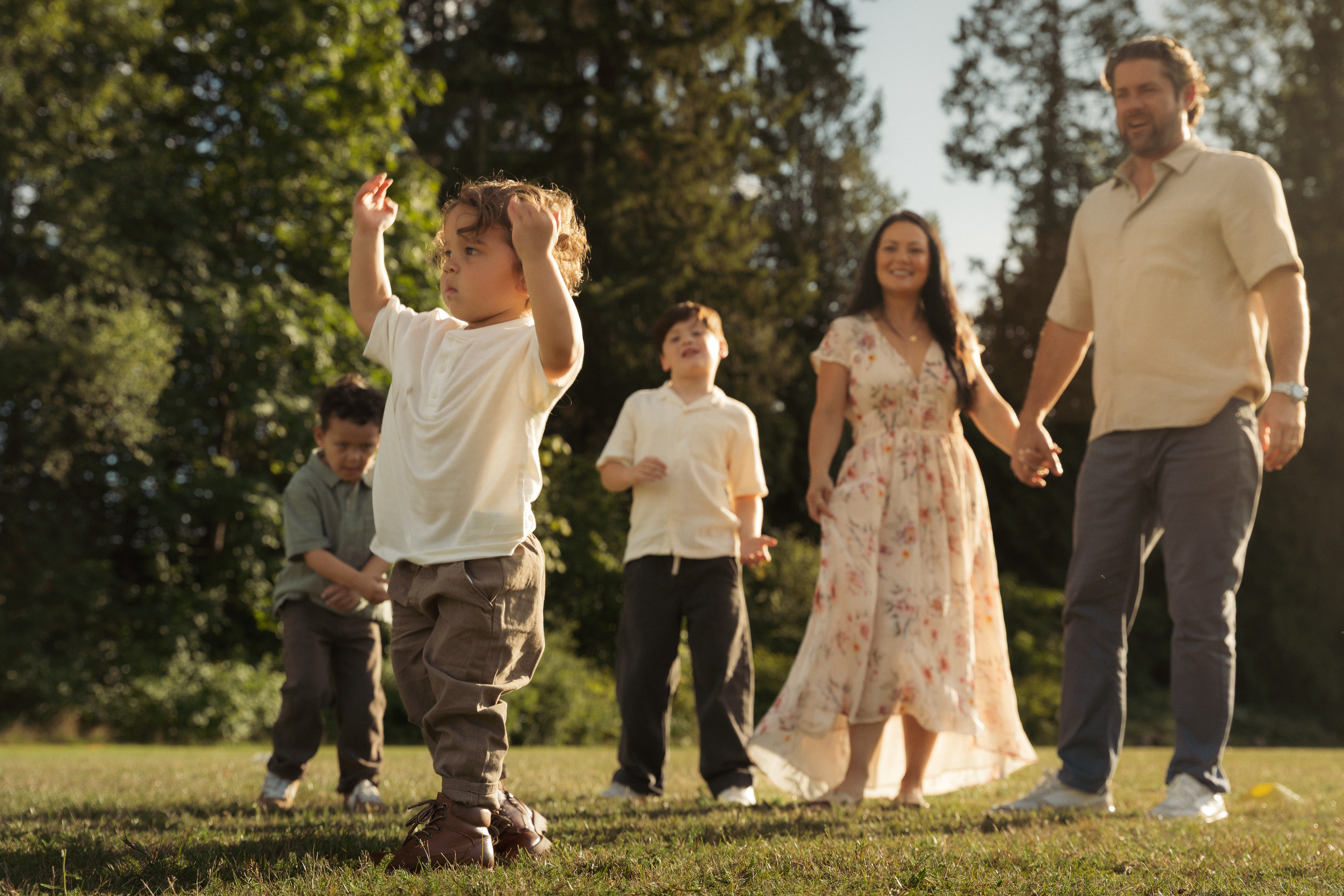 A family walking and playing together in warm evening light